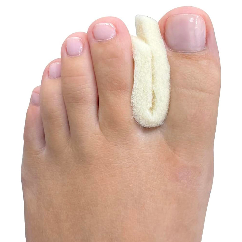 Toe separator pad worn on foot to guide big toe alignment