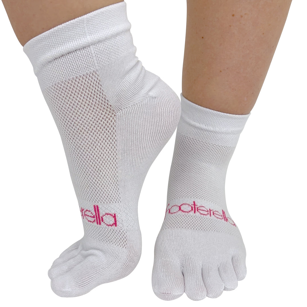 A pair of white toe socks with the brand 'FOOTERELLA' printed on the side, designed to be worn on the feet to promote straight toes and better toe alignment.