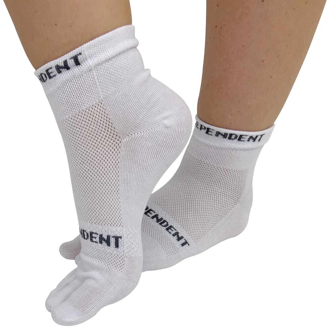 A pair of white independent toe socks designed to encourage straight toes and better toe alignment, with visible brand text on the side.