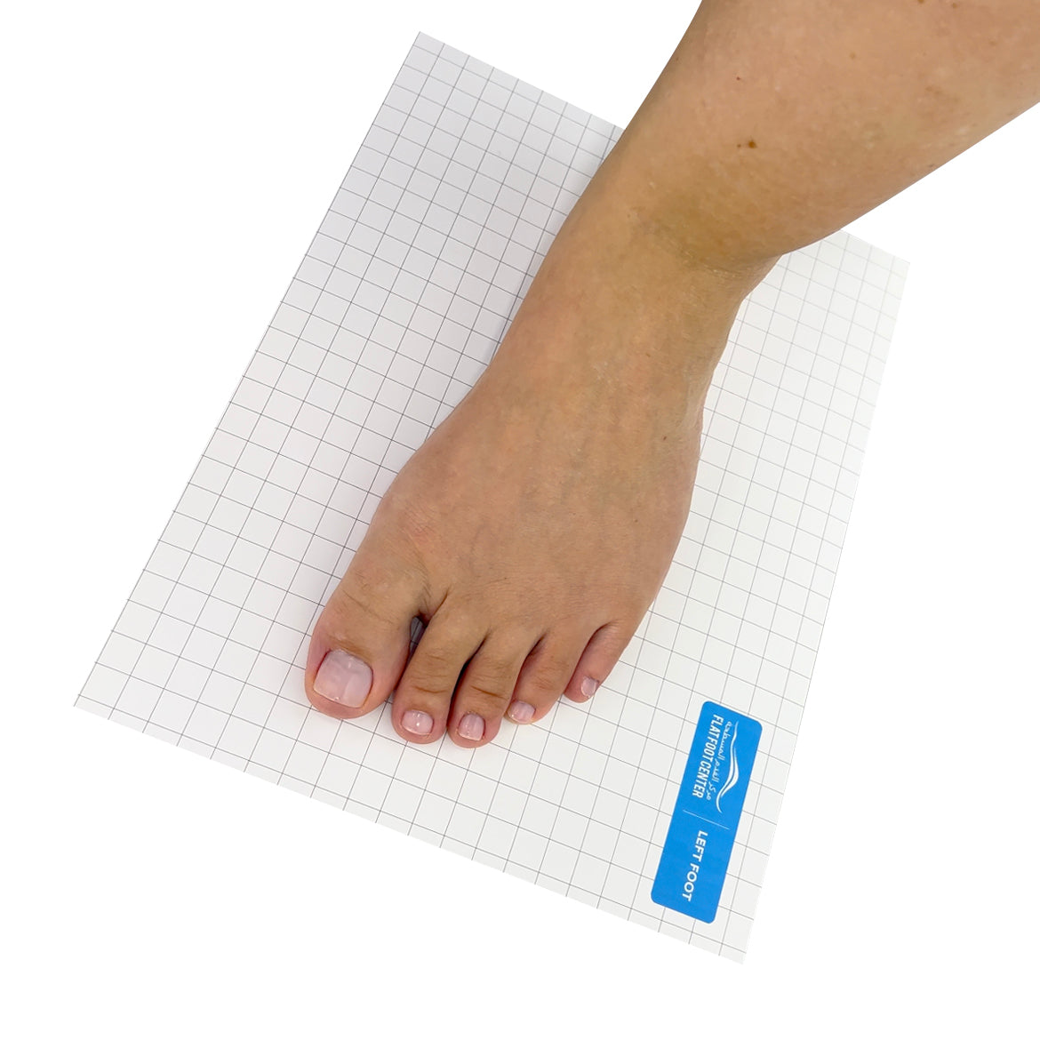 Left foot placed on a white grid line paper to capture the footprint, with the product's brand visible on the paper.